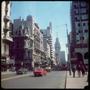 Photograph: [Vehicles and pedestrians on a street in Montevideo]