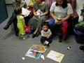 Photograph: [Women sit with toddlers during ILD event, 1]