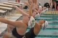 Photograph: [UNT and NMSU competitors dive into backstroke event]