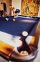 Photograph: [Mike Modano standing hunched over pool table]
