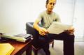 Photograph: [Mike Modano sitting in an office reading a documents]