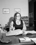 Photograph: [Nancy Menchaca working as a secretary at Plains Machinery Co.]