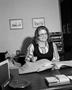 Photograph: [Nancy Menchaca working in the office of Plains Machinery Co.]
