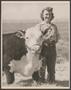 Photograph: [A woman posing with a cow]