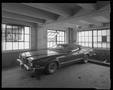 Photograph: [Car in a garage with an open window]