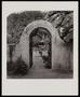 Photograph: [An arched entrance with wood doors]