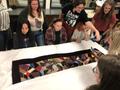 Photograph: [Students in looking at historic quilts]