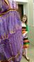 Photograph: [Annette Becker presenting a purple Zandra Rhodes design]