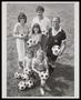 Photograph: [Three adults and three kids posing with soccer balls]