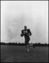 Photograph: [Football Player No. 24 Running with a Ball, September 1962]