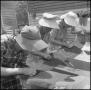 Photograph: [Women at an outdoor quilting bee]