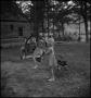 Photograph: [Children playing on swing]