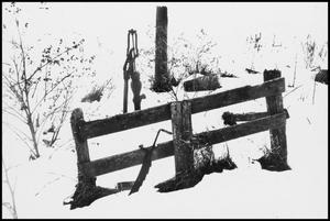 Primary view of object titled '[Water pump in a snowy field behind a fence]'.