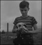 Primary view of [Raymond Clark holding a human skull, 2]