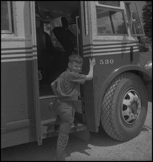 Primary view of object titled '[Raymond Clark boarding a bus]'.