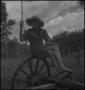 Photograph: [Raymond sitting on a wheel, 2]