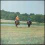 Photograph: [Two Riders on Horses on a Field]