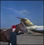 Photograph: [Woman and horse next to a plane (close up)]