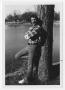 Photograph: [Bill Nelson leaning against a tree]