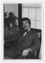 Photograph: [Bill Nelson sitting in chair]