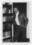 Primary view of [Bill Nelson leaning on bookcase]