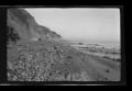Photograph: [Model T automobiles driving along a shoreline]