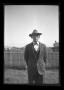 Photograph: [Byrd Williams, Jr. standing in a backyard]