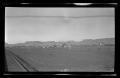 Photograph: [A railroad track alongside a desert town]