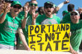 Photograph: [Mean Green Fan Holding up Sign]