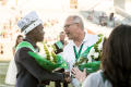 Photograph: [Crowned Homecoming Court shaking UNT President Neal J. Smatresk's Ha…