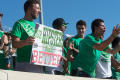Photograph: [Mean Green Fan Holding up Sign at Homecoming Game]