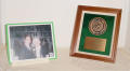 Photograph: [Shelf with a photograph and an award]