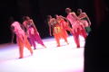 Photograph: [Ensemble in colorful costumes leaning over]