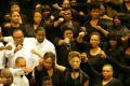 Photograph: [Choir members raising a fist]