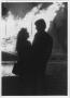 Primary view of [Couple silhouetted against North Texas Homecoming bonfire, c. 1980]