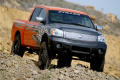 Photograph: [Black and orange Nissan truck on hill]