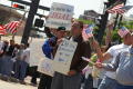 Primary view of [Group of male protesters with signs in English and Spanish]