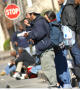 Photograph: [Homeless man eating while standing on street corner]