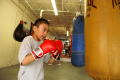 Photograph: [Boy hitting heavy boxing bag]