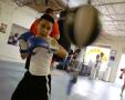 Primary view of [Boy hitting speed bag with blue boxing gloves]