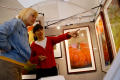 Photograph: [Two women looking at artwork, one pointing with her left hand]