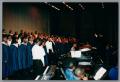 Photograph: [Choir ensemble looking at conductor]