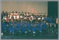Photograph: [Band and choir ensemble members on stage]