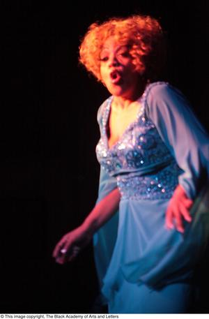 [Actress performing in blue dress]