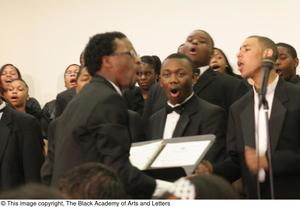 [Conductor and choir performing together]