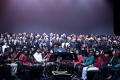 Thumbnail image of item number 1 in: '[Group picture of a choir and an orchestra on stage, 3]'.