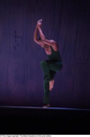 Primary view of object titled '[Photograph of a man in a green leotard dancing on one leg]'.