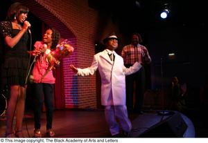 [Kirondria Woods, Rachel Webb, boy in white suit, and Curtis King on stage]