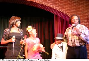 [Kirondria Woods, Rachel Webb, and boy in white suit, standing on stage with Curtis King]