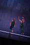 Photograph: [Photograph of a woman and man dancing on stage in green leotards]